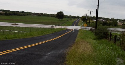 Women Hollaring Creek over the road, been some time since it has done this.